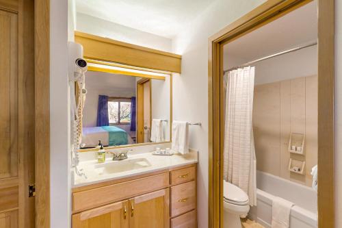 a bathroom with a sink and a toilet and a mirror at Ludlow Seaside Hale' in Port Ludlow