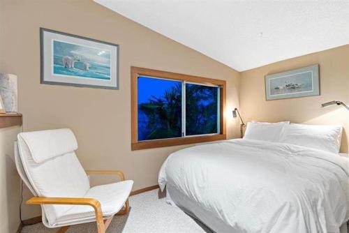 a bedroom with a bed and a chair and a window at Vancouver sea view Palace inn in West Vancouver