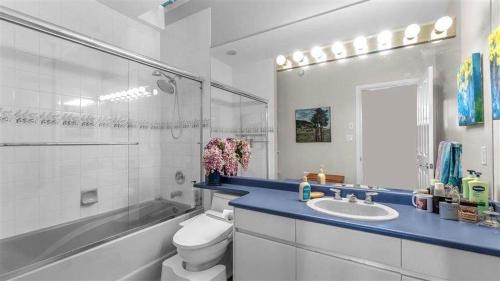 a white bathroom with a sink and a toilet at Vancouver sea view Palace inn in West Vancouver