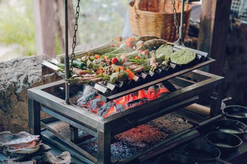 a bunch of vegetables cooking on a grill at ANAND Ecoaldea in Puerto Morelos