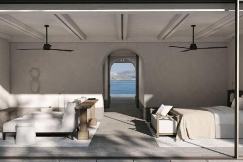 a bedroom with a bed and a view of the ocean at Odera, Tinos, Autograph Collection in Kionia