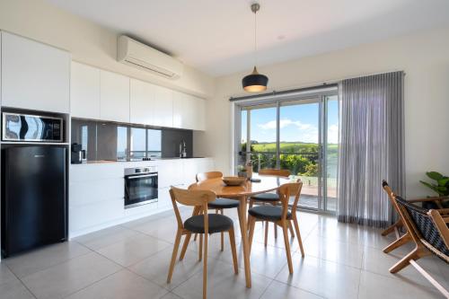 a kitchen and dining room with a table and chairs at Sea&Country Kiama-Stunning Views-Relaxing-Spacious-Deck-EVC-Travellers Award 2025 & 2026 in Kiama