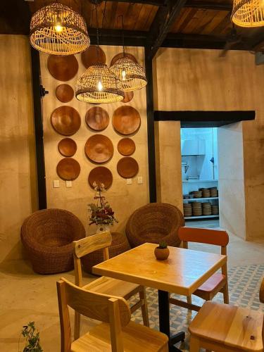 a dining room with a table and chairs and lights at Hotel Mansión Chiapa in Chiapa de Corzo