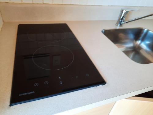 a tablet sitting on a counter next to a sink at Alfa Boutique Motel in Paihia