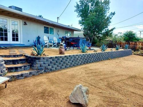 a retaining wall in front of a house at Cozy Stylish Home in the Heart of JT Village in Joshua Tree