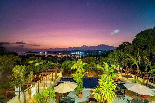 a view of a resort with a pool and trees at Hotel Palacio Puerto Princesa in Puerto Princesa City