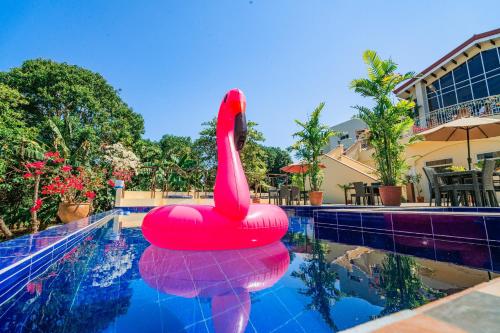 a pool with a red swan float in the water at Hotel Palacio Puerto Princesa in Puerto Princesa City