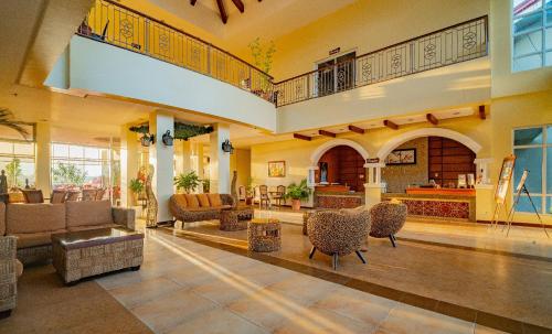 a large living room with couches and chairs at Hotel Palacio Puerto Princesa in Puerto Princesa City