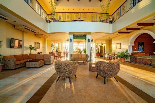 a large living room with couches and chairs at Hotel Palacio Puerto Princesa in Puerto Princesa City