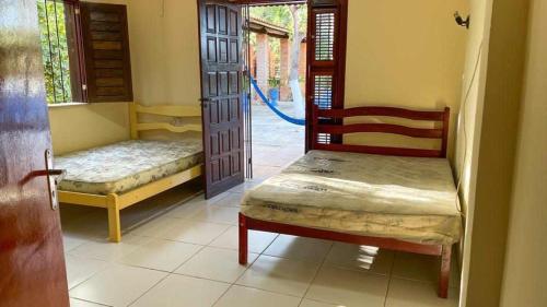 מיטה או מיטות בחדר ב-Chácara Sitio Icaraí Caucaia-CE