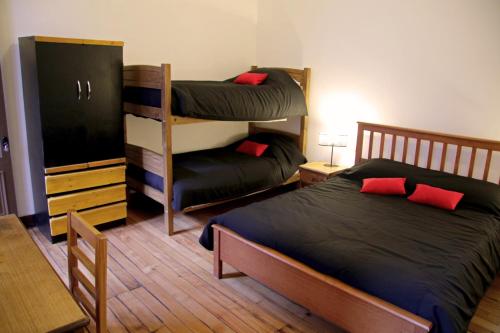 a bedroom with two bunk beds and a table at Hostal Irreal in Santiago