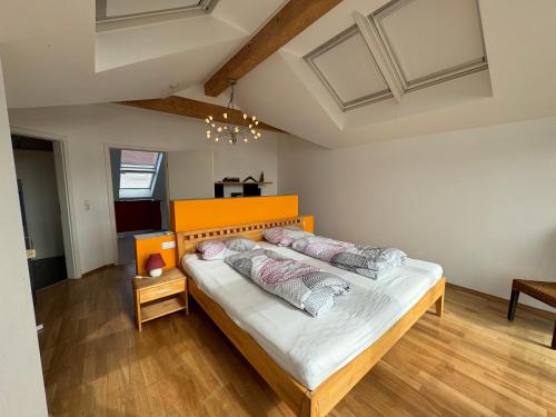 a bedroom with a large bed with two pillows at Ferienhaus Bergblick in Tettnang