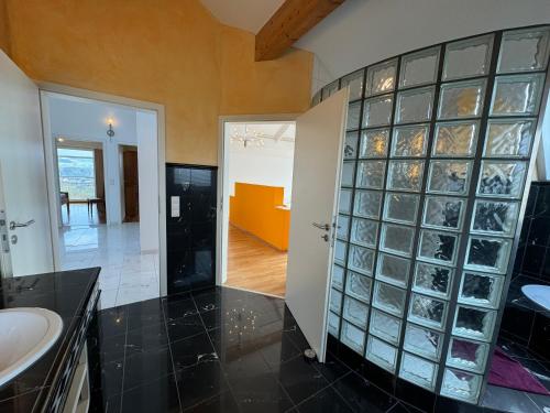 a bathroom with a sink and glass block wall at Ferienhaus Bergblick in Tettnang