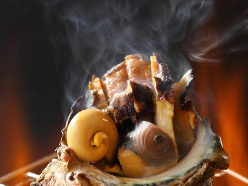 a piece of food with smoke coming out of it at Hanashibuki in Tateyama