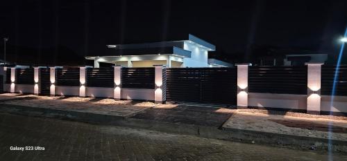 a fence in front of a building at night at Paradijs in Paramaribo in Paramaribo
