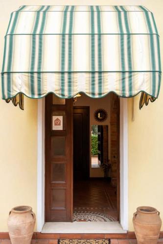 awning over the entry to a house with two vases at cs veniceflat Apartment - Venice - Apt Vce - 15' from Venice in Tessera