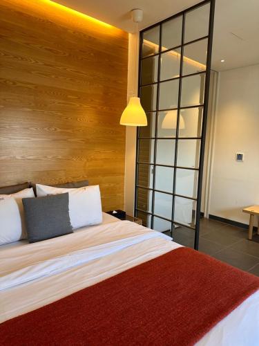 a bedroom with a large bed with a wooden headboard at Gwangju Hotel the spot in Gwangju