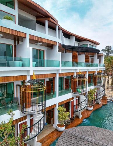 an apartment building with bird cages on its balconies at Hotel Villa AoKhanom Beachfront in Khanom
