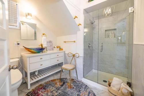 a bathroom with a shower and a toilet and a stool at Luxury Living, Walkers Paradise, Hidden Oasis in Oakland