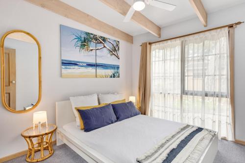 a bedroom with a bed and a large window at Hot Springs Landing Pad in Rye