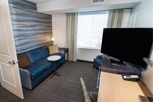 a hotel room with a couch and a tv at Residence Inn by Marriott Rocklin Roseville in Roseville