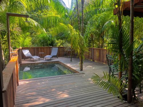 a patio with a pool and a chair on a deck at Ti Kaz Açaï in Le Lamentin