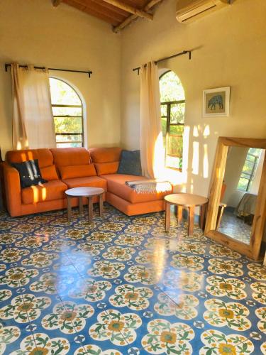 a living room with a couch and two tables at The Traveler Palm B and B in El Limón