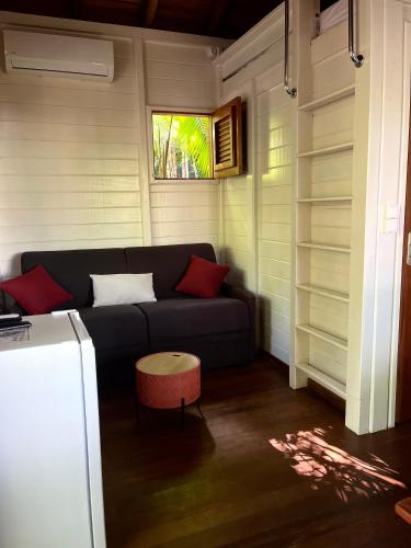 a living room with a couch and a window at Ti Kaz Açaï in Le Lamentin