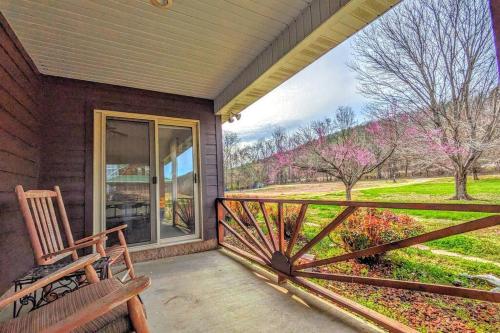 a porch with a wooden bench and a window at Fishing Cabin on White River w/ public boat ramp! in Norfork