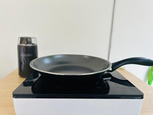 a black pan sitting on top of a stove at Guest house in Altos del Maria in Sorá