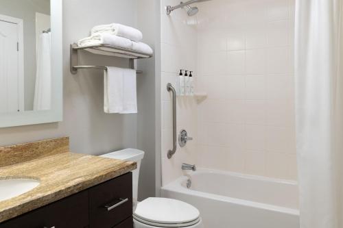 a bathroom with a shower and a toilet and a sink at TownePlace Suites by Marriott Sacramento Roseville in Roseville