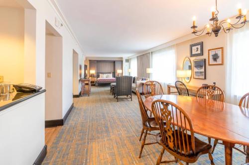 a dining room and living room with a table and chairs at Williamsburg Lodge, Autograph Collection in Williamsburg