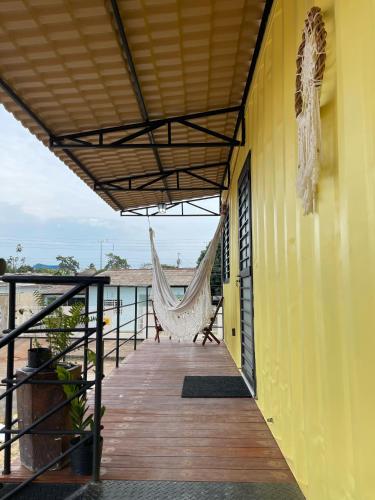 a hammock on the balcony of a house at Suíte Contêiner Roraima in Boa Vista