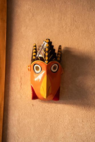 a mask hanging on the side of a wall at La Paranera Hotel & Relax in Comala