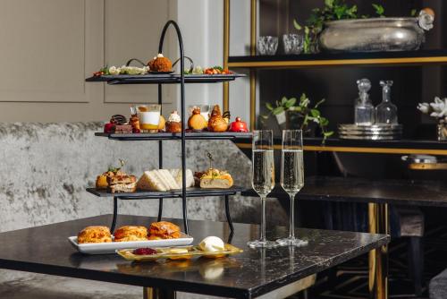 a table with a display of food and wine glasses at Fable Auckland, MGallery in Auckland