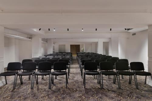 an empty room with a bunch of chairs in it at Fable Auckland, MGallery in Auckland