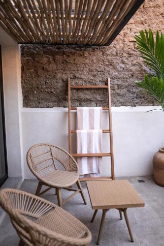 a towel rack with a chair and a table at La Paranera Hotel & Relax in Comala