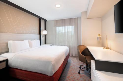 a hotel room with a bed and a desk at Springhill Suites by Marriott Conyers in Conyers