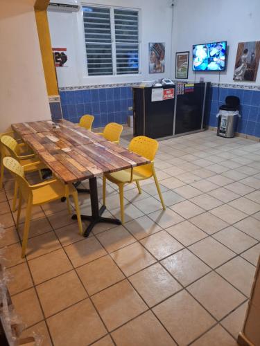 a wooden table and chairs in a room at Humacao guest house in Humacao