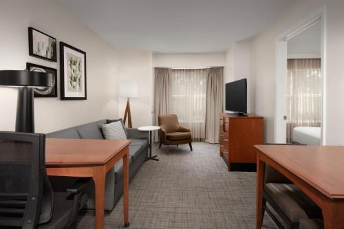 a living room with a couch and a tv at Residence Inn by Marriott Fayetteville Cross Creek in Fayetteville