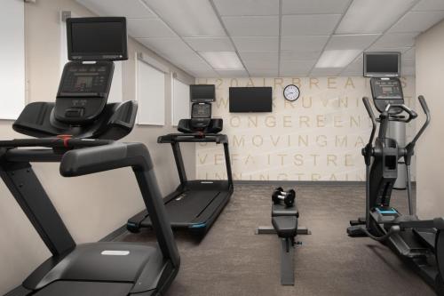 a room with a gym with two cell phones at Residence Inn by Marriott Fayetteville Cross Creek in Fayetteville