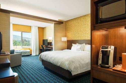 a hotel room with a bed and a television at Fairfield Inn & Suites by Marriott San Diego North/San Marcos in San Marcos