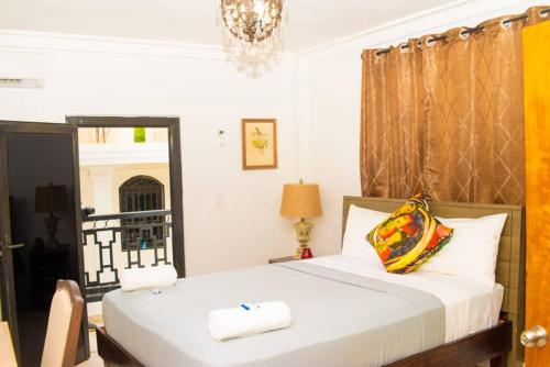 1 dormitorio con cama y lámpara de araña en Duen, en Delmas
