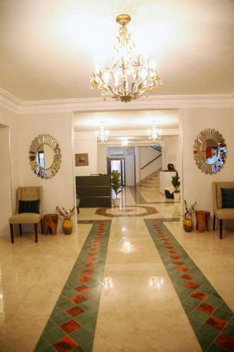 a large living room with a chandelier and a rug at Duen in Delmas