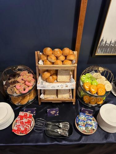 a table topped with different types of bread and pastries at U Sabai Hotel Bangkok in Bangkok