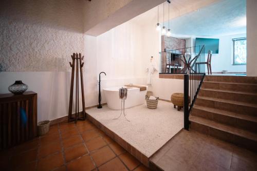 a bathroom with a bath tub and a staircase at BOTANIQ HOTEL BOUTIQUE in Valle de Bravo