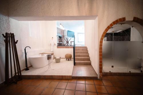 a bathroom with a shower and a tub and a sink at BOTANIQ HOTEL BOUTIQUE in Valle de Bravo
