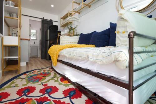 a bedroom with a bed and a rug at Tiny Living; Big Style in Oakland