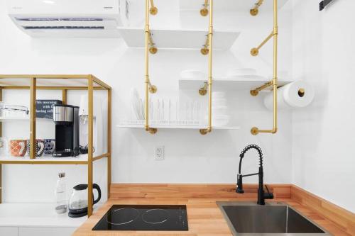 a kitchen with a sink and a counter at Tiny Living; Big Style in Oakland