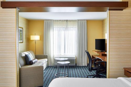 a hotel room with a couch and a table at Fairfield Inn & Suites by Marriott Atlanta Lithia Springs in Lithia Springs